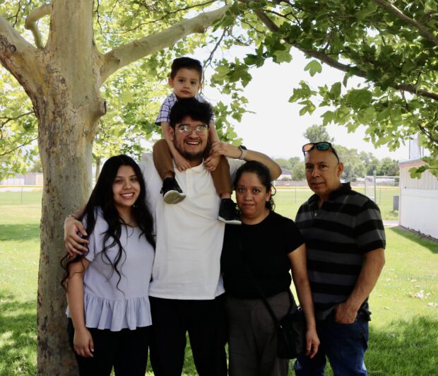David Castillo-Rojas (center) poses with his son David Jr. (top), son's mother, Jocelyn Flores (left), mother Magda Rojas (center right) and Enrique Acevedo (right)