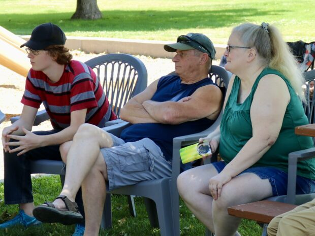 Graduate Riley Koslowski (left) and his grandparents Harold and Terri Koslowski watch as GED certificates are presented.