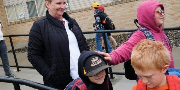 Highland Superintendent Tana Kellogg smiles as she helps students get on their buses after school on Monday, May 19, 2025, in Craigmont, Id.
